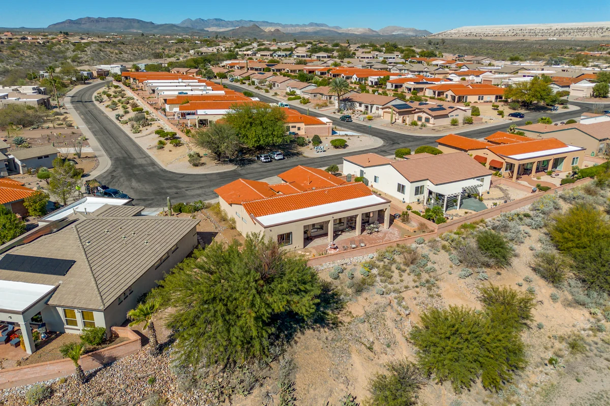 Daytime aerial of a home on Tropicana Drive and its San Ignacio Vistas II neighborhood setting